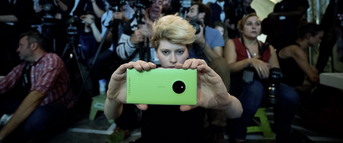 woman using a mobile phone at fashion show, Fashion Innovation Agency